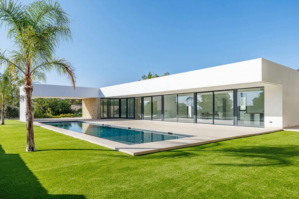 A modern Mediterranean property exterior with a pool, the kind of listing photo a real estate agency keeps in its CRM